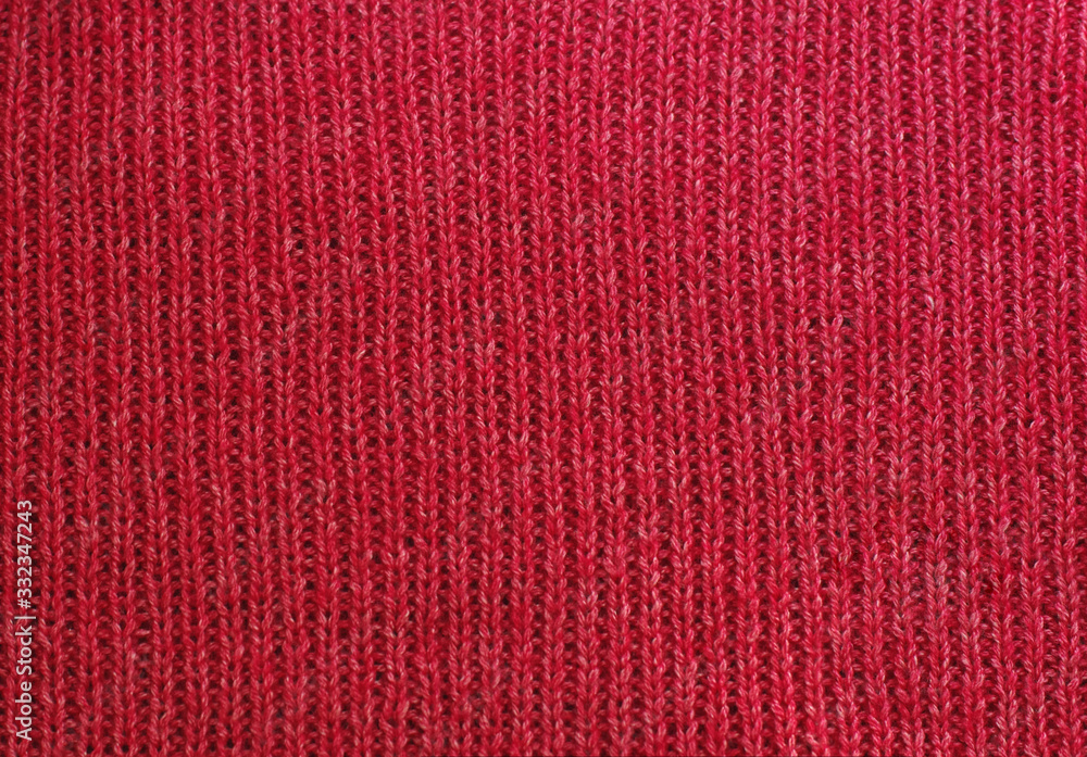 The texture of a knitted woolen fabric red. The texture of a knitted woolen fabric red.