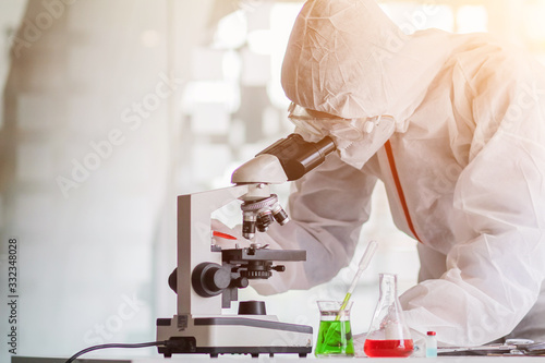 The medical team wore a coronavirus protective suit and rubber gloves to examine the coronavirus covid-19 and research for a vaccine to prevent coronavirus covid-19 to stop the epidemic. photo