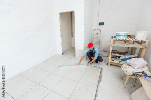 Installing Luxury tiles on the floor © Angelov