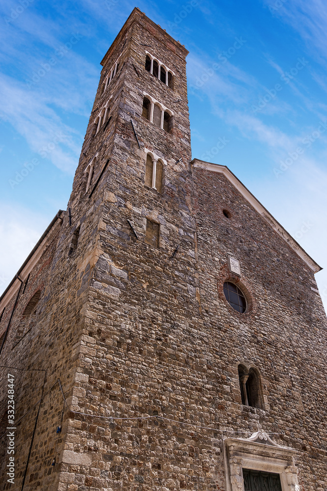Facade and bell tower of the church of Saint Andrea (X-XVI century) in Romanesque Gothic style in Sarzana town, La Spezia, Liguria, Italy, Europe