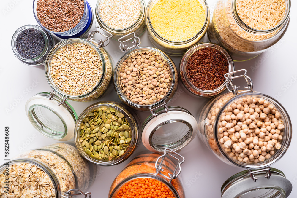 Dry grains, legumes and seeds in glass jars, top view Dry grains, legumes and seeds in glass jars, top view