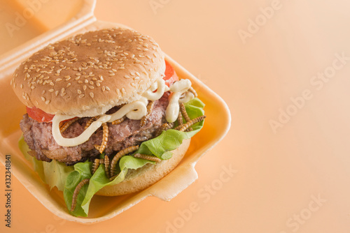 Burger of endible worms  with tomato and lettuce photo