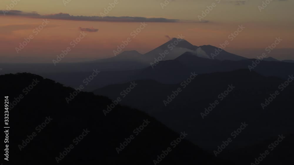 4K UHD Timelapse of Telica and San Cristóbal volcano, in Nicaragua, smoking in the distance behind layers of hills and mountains during sunset. 4K UHD Timelapse of Telica and San Cristóbal volcano, in Nicaragua, smoking in the distance behind layers of hills and mountains during sunset.