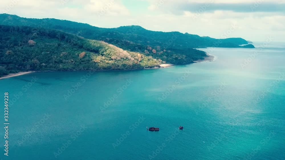 Aerial view of ocean and Island with abandoned ship - Drone shot Aerial view of ocean and Island with abandoned ship - Drone shot