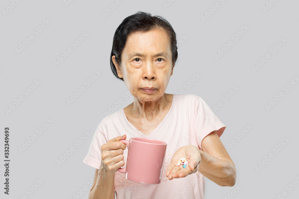 old asian woman feel have fever and sick holding medication to take medicine old asian woman feel have fever and sick holding medication to take medicine