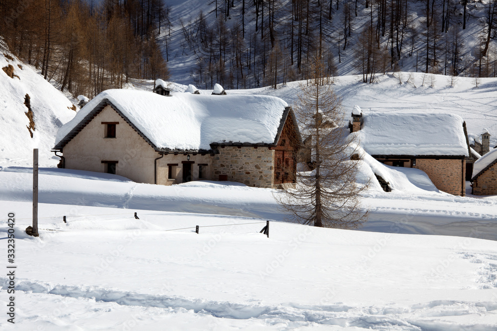 Devero Park ( Verbano-Cusio-Ossola ), Italy - January 15, 2017: Crampiolo village and houses in Alpe Devero Park, Ossola Valley, VCO, Piedmont, Italy