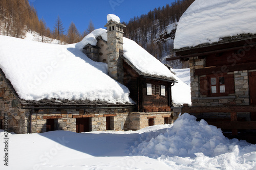 Devero Park ( Verbano-Cusio-Ossola ), Italy - January 15, 2017: Crampiolo village and houses in Alpe Devero Park, Ossola Valley, VCO, Piedmont, Italy photo