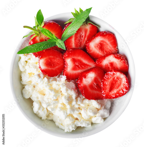 White bowl with fresh red ripe strawberries and natural cottage cheese