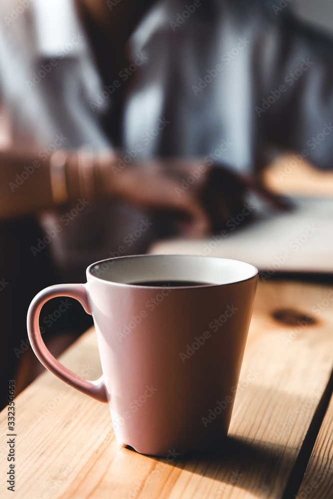 Woman in the morning drinks coffee and reads old book in a white shirt. Education, drink. manicure Woman in the morning drinks coffee and reads old book in a white shirt. Education, drink. manicure