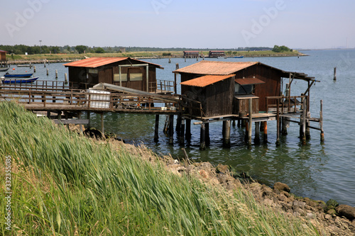 Po river (FE), Italy - April 30, 2017: Fisherman's houses on Po river, Delta Regional Park, Emilia Romagna, Italy