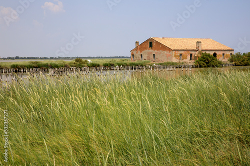 Po river (FE),  Italy - April 30, 2017: An old Fisherman's house on Po river, Delta Regional Park, Emilia Romagna, Italy photo