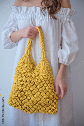 Young girl with brunette hair holds eco bag. Zero wasty. Stop polution be resonsible photo