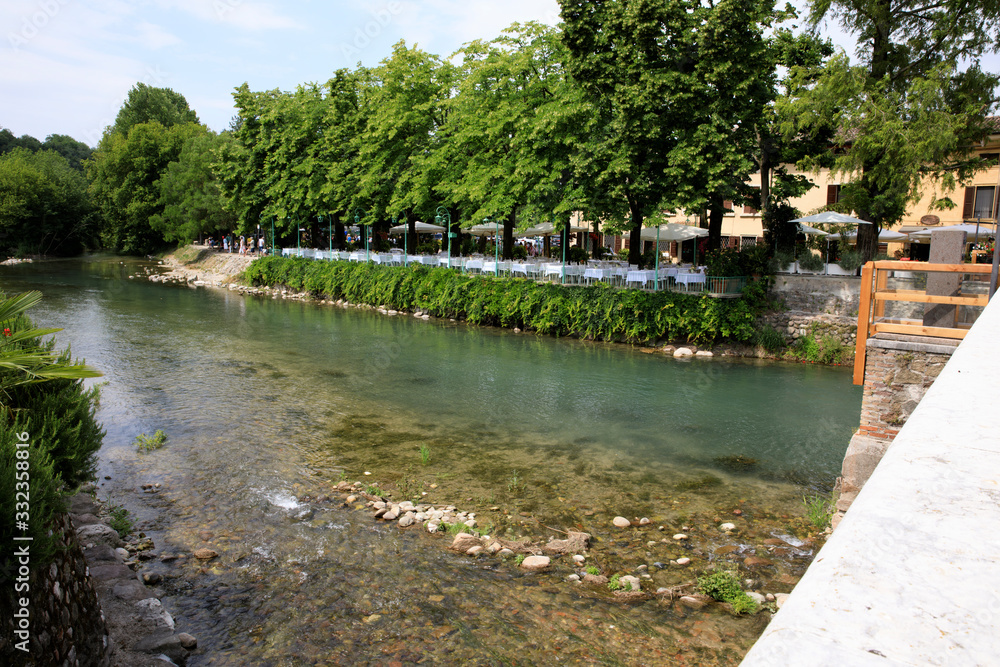 Borghetto (VR), Italy - April 30, 2017: Mincio river in Borghetto village, Mincio, Verona, Veneto, Italy Borghetto (VR), Italy - April 30, 2017: Mincio river in Borghetto village, Mincio, Verona, Veneto, Italy