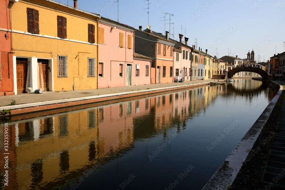 Comacchio (FE),  Italy - April 30, 2017: Houses in Comacchio village reflecting in the water, Delta Regional Park, Emilia Romagna, Italy