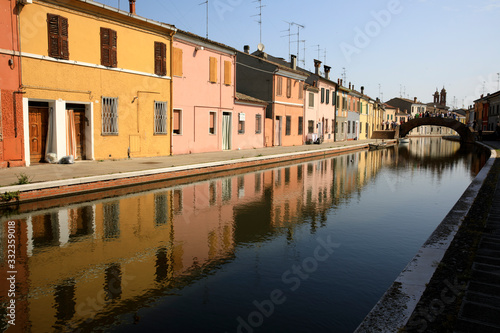 Comacchio (FE),  Italy - April 30, 2017: Houses in Comacchio village reflecting in the water, Delta Regional Park, Emilia Romagna, Italy © PaoloGiovanni