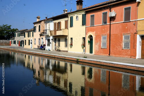 Comacchio (FE), Italy - April 30, 2017: Houses in Comacchio village reflecting in the water, Delta Regional Park, Emilia Romagna, Italy