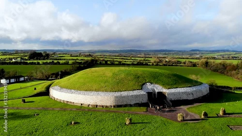 Newgrange round building in green field in ireland