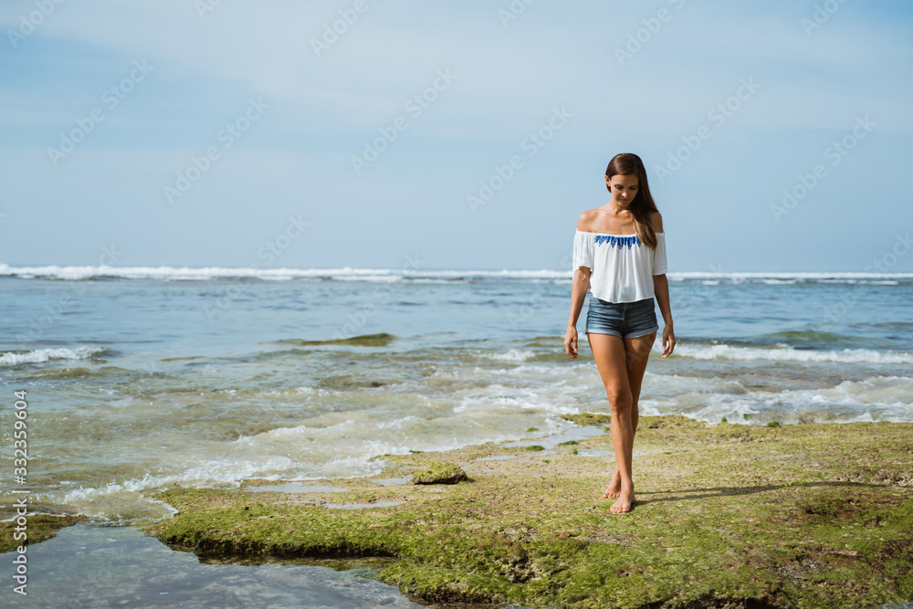 young slim beautiful woman on the beach