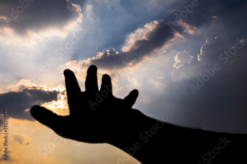 Hand reaching into the sky.  Hand Reaching the Sky, connection, earth, far away, hands. Hand Reaching for the Sky during Dusk