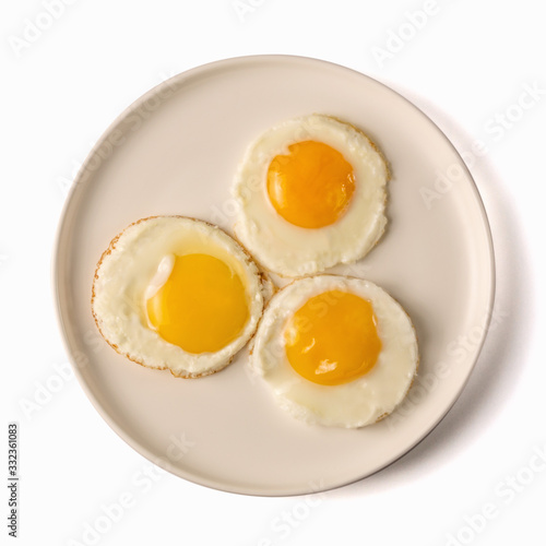 tree fried eggs on white plate isolated on white background