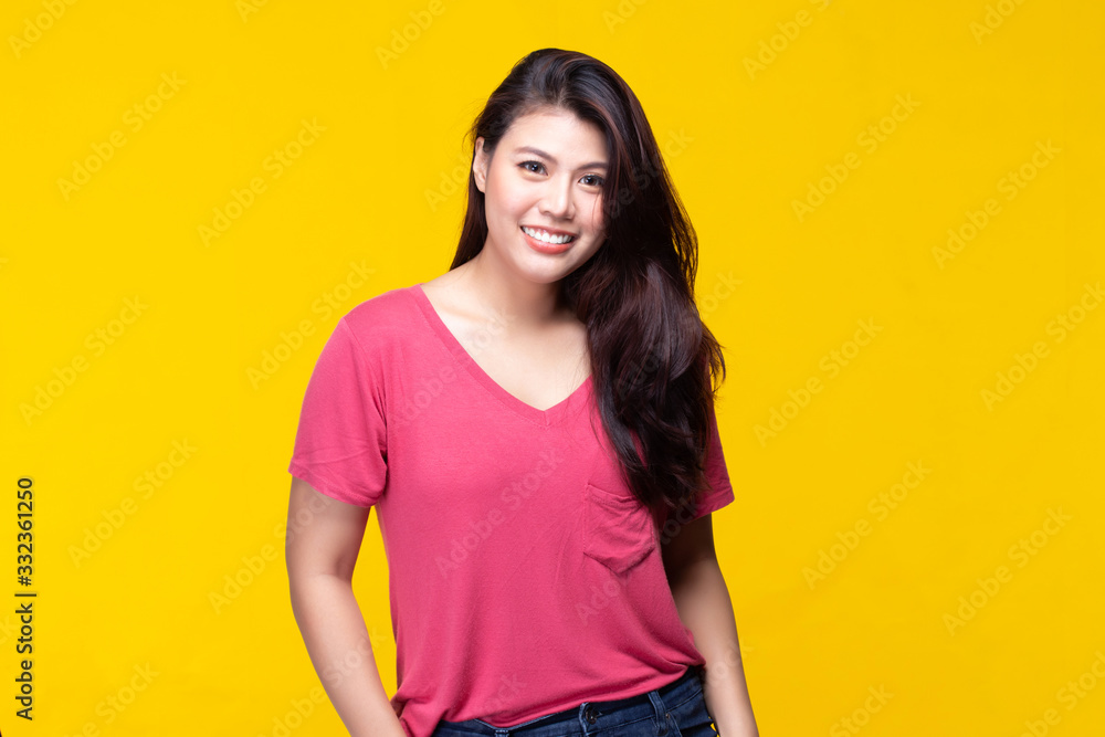Image of feeling smile and happy. Cheerful young asian woman with brunette long hair in casual shirt smiling with teeth on yellow background. Female face expressions and emotions concept. Image of feeling smile and happy. Cheerful young asian woman with brunette long hair in casual shirt smiling with teeth on yellow background. Female face expressions and emotions concept.