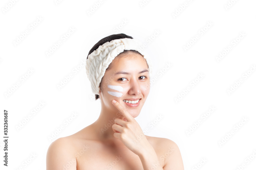 Beautiful half naked model young woman applying cosmetic cream treatment on her face isolated on white background. Skincare and cosmetics concept. Woman face skin care concept. Beautiful half naked model young woman applying cosmetic cream treatment on her face isolated on white background. Skincare and cosmetics concept. Woman face skin care concept.