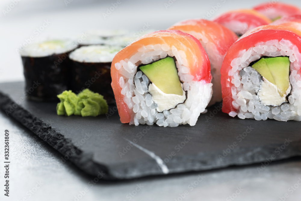 Sushi maki with avocado and sushi philadelphia on a background of slate board. Sushi maki with avocado and sushi philadelphia on a background of slate board.