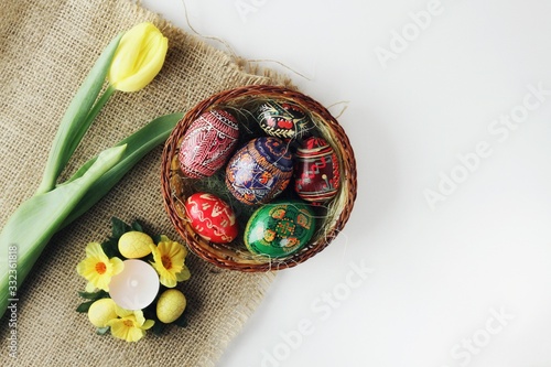 Beautiful Eastern style flat lay with traditional painted eggs and tulips
