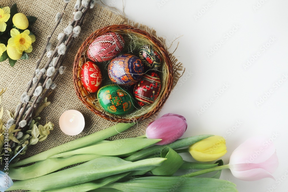 Beautiful Eastern style flat lay with traditional painted eggs and tulips