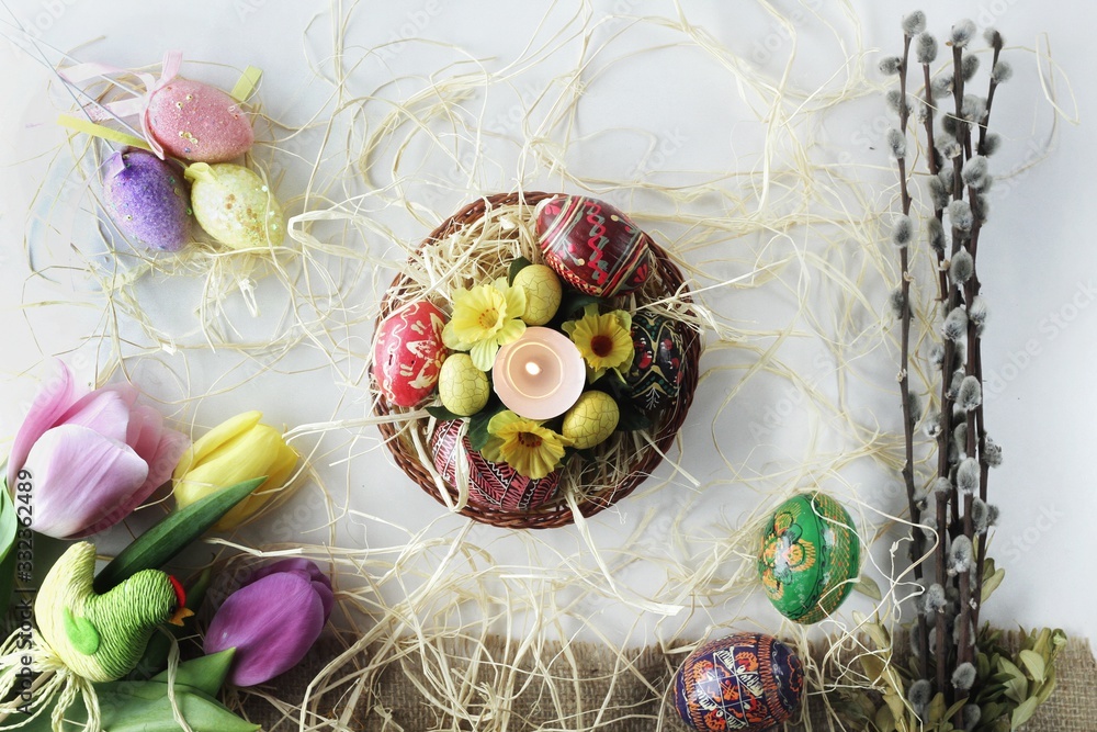 Beautiful Eastern style flat lay with traditional painted eggs and tulips