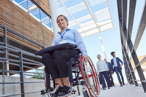 Disabled businesswoman in a wheelchair on a ramp