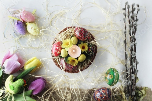Obraz na płótnie Beautiful Eastern style flat lay with traditional painted eggs and tulips w salonie