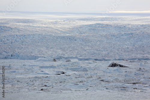 Aerial view of glacier flowing into the Arctic Ocean