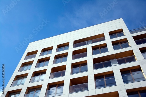 Exterior of new apartment buildings on a blue cloudy sky background. No people. Real estate business concept.