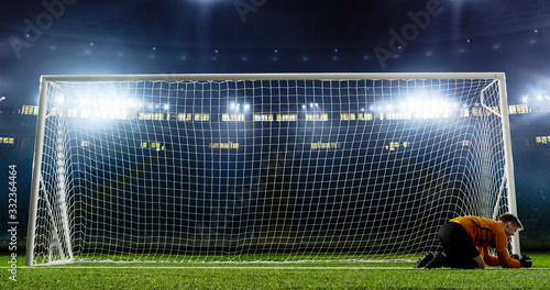 Photos Goalkeeper is trying to save from a goal on an empty soccer stadium