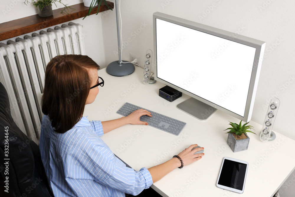 Young cheerful woman working with computer