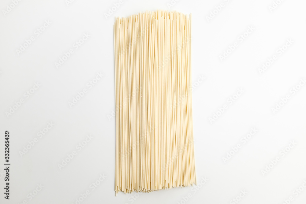 Dry noodles made from wheat flour on white background