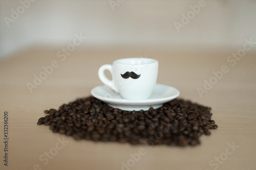 Coffee cup on a mountain full of coffee beans