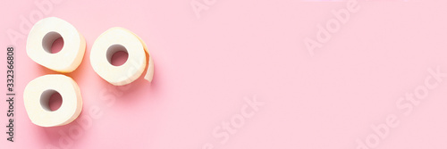 toilet paper rolls on a pink background. Flat lay, top view. Baner. Hygiene concept, deficiency, quarantine