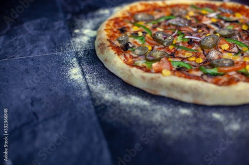 Veggie pizza over a rustic background