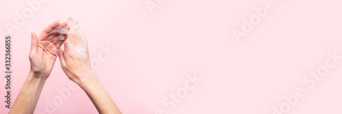 Hand washing. Soapy female hands on a pink background. Concept of the rules of washing and handling hands. Top view  flat lay. Banner