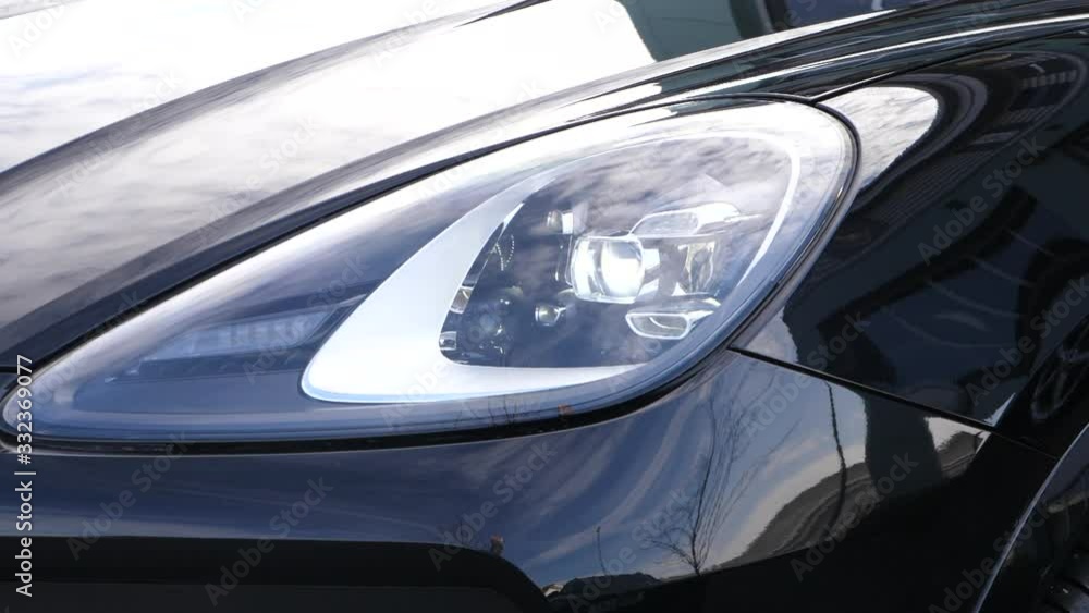 Detail shot of black SUV headlight Detail shot of black SUV headlight