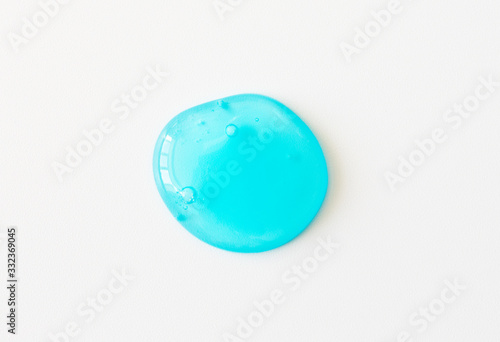 Blue shower gel or fresh transparent toothpaste spot with air bubbles on white background. Cosmetic healthcare texture