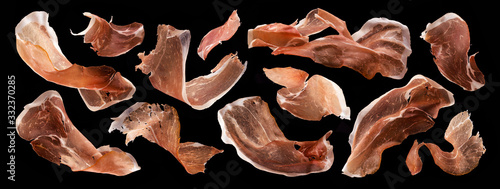 Photos Sliced jamon, dry italian prosciutto crudo, spanish ham on black background