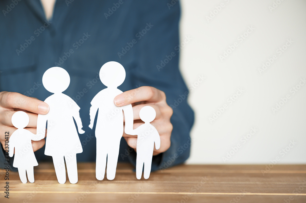 Break up and divorce. Relationship breakdown in family concept. Parting husband and wife. Female hands holding torn paper people figures. Blank copy space