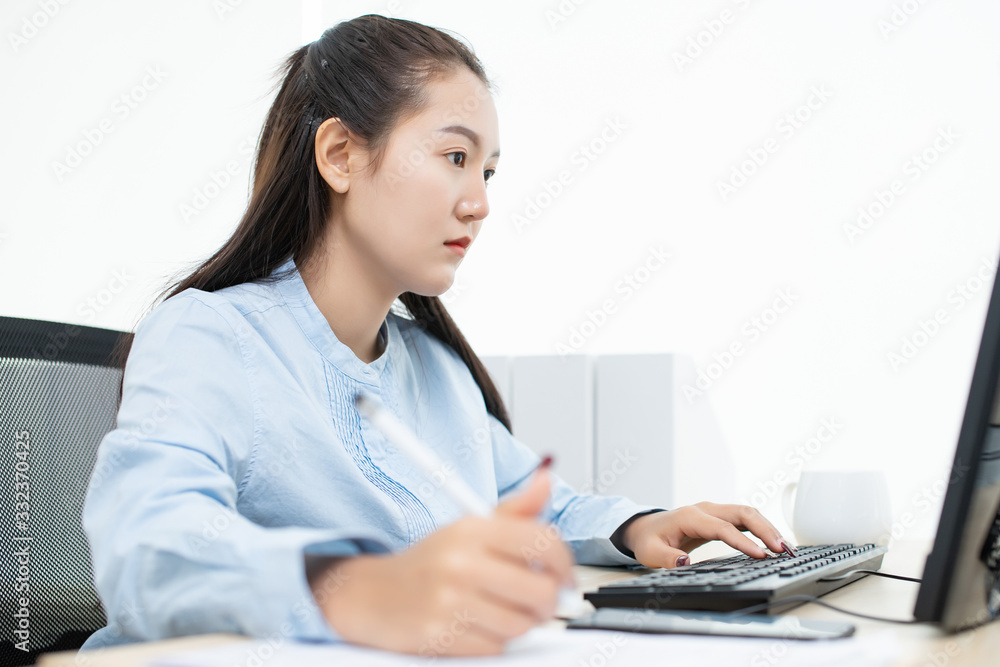 Asian success businesswoman happy using laptop computer connect internet working from home in glass room big window with copy space Asian success businesswoman happy using laptop computer connect internet working from home in glass room big window with copy space