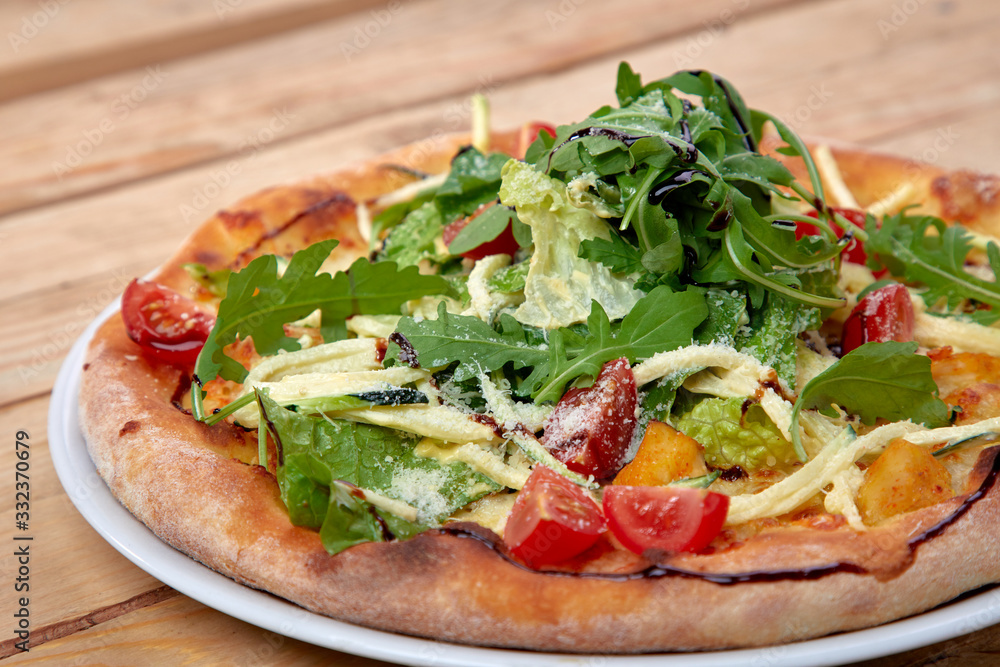 pizza with fresh vegetables on the wooden background pizza with fresh vegetables on the wooden background