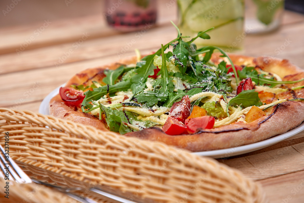 pizza with fresh vegetables on the wooden background pizza with fresh vegetables on the wooden background
