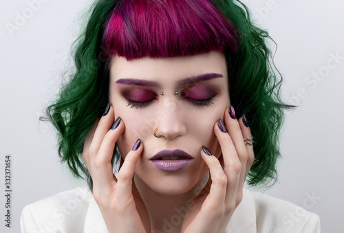 Beautiful woman with purple green professional colored hair photo