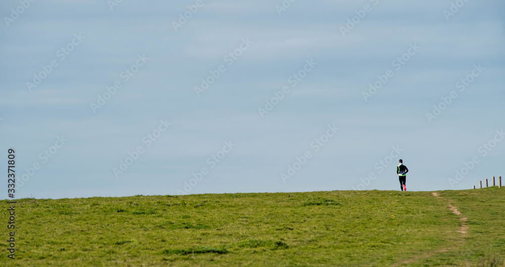 man jogging in a pretty green landscape man jogging in a pretty green landscape
